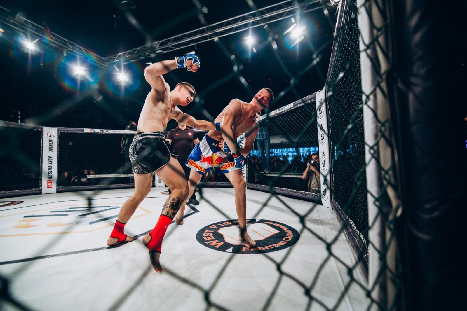 A fighter throws a punch during a fast exchange inside the MMA cage.