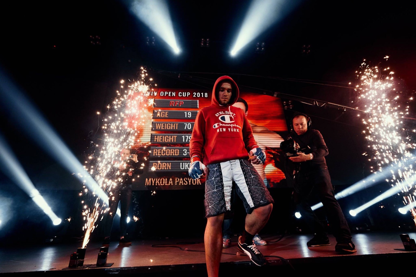 A fighter enters the RFP arena between fountains of sparks.